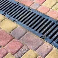 Stormwater cast iron drainage system in a pavement. Is used for drainage and separation of water from footpath.
