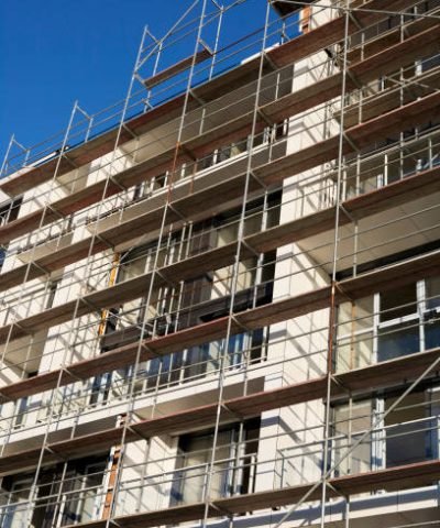 a fortified building under construction against a gray sky background
