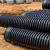 Flowing rainwater into main collecting container using plastic black pipes