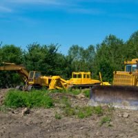 Mechanical Site Preparation for Forestry. Excavator and bulldozer clearing forest land.